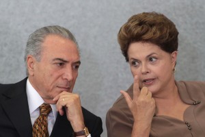 Brazils President Dilma Rousseff, right, talks with her Vice President Michel Temer during a ceremony at Planalto Palace in Brasilia, Brazil, Tuesday, April 24, 2012. Activists are warning that a proposed revamp of Brazil's tough environmental law could roll back historic gains in the fight against Amazon deforestation by opening parts of the rainforest to farming and increasing impunity for violators. The bill was approved by Brazil's Senate in December and is expected to be easily passed by the lower house of Congress on Tuesday. It would then go to Rousseff, who has said she opposes parts of the reform and has promised to use her line-item veto powers on the proposed legislation. (AP Photo/Eraldo Peres)